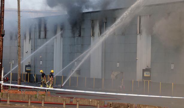 Fire fighters battle with a fire at Storage World in Middleton