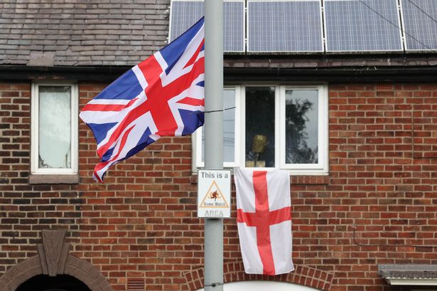 Union Jack and England flags appear on lampposts all along Victoria Avenue in Blackley, Manchester.