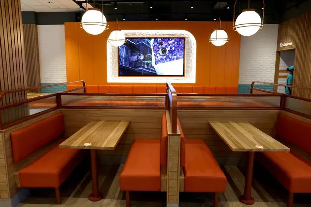 The new Manchester store features 85 seats, as well as self-service kiosks and collection points