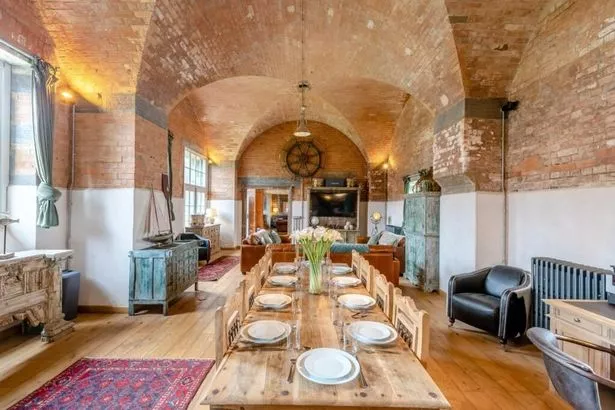 The substantial formal dining room with lounge area at one end at Thorne Island and Fort just off the coast of Angle, Pembrokeshire