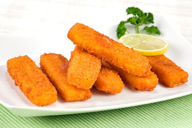 Fried fish fingers on plate. 