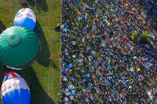 Saturday 10 August 2024. People lay in the sun around picnics and blankets as they watch  hot air balloons take to the sky at Saturday evenings mass ascent during the Bristol International Balloon Fiesta this weekend, where 65 balloons lifted off from Ashton Court in Bristol.    PHOTO:PAUL GILLIS / Reach Plc
