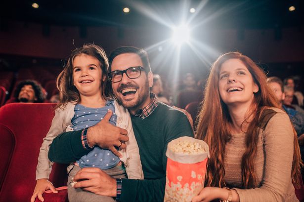 A family enjoying a cinema trip together