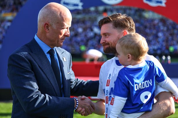 Birmingham City chairman Tom Wagner shakes the hand of striker Alfie May following the League One trophy lift