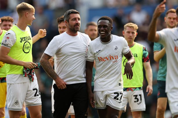 Swansea City Manager Alan Sheehan and Zeidane Inoussa celebrate