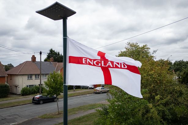 A flag flies above a residential street in Birmingham on August 18