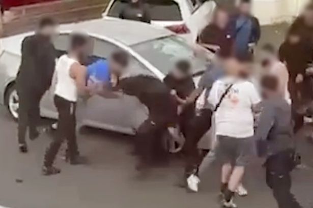 Shocking footage shows the moment a huge" Wild-West style" mass brawl erupted in the middle of a residential street involving up to 20 people