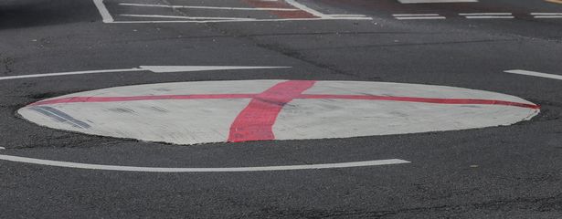 A roundabout on the junction of Priory Road, Trittiford Road and Highfield Road which has been painted with a St George's Flag. 