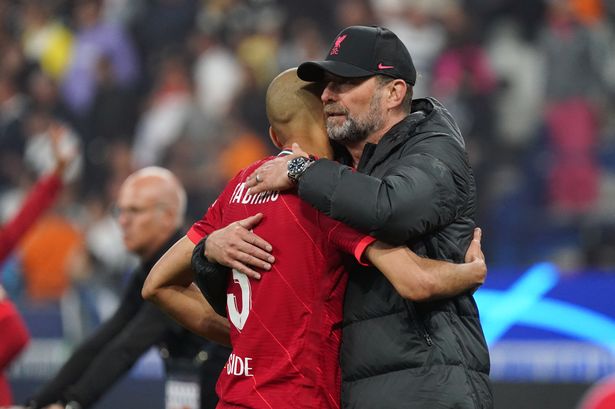 Liverpool manager Jürgen Klopp embraces Fabinho after the UEFA Champions League final match between Liverpool FC and Real Madrid at Stade de France on May 28, 2022 in Paris, France.