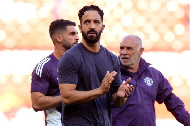 Manchester United boss Ruben Amorim (centre) applauds the fans 
