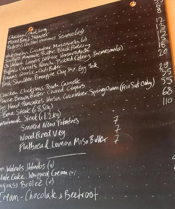 The menu at Mesen on a blackboard on a restaurant wall featuring a number of sharing plates