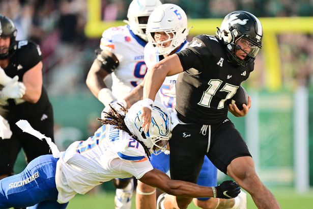 Byrum Brown #17 of the South Florida Bulls breaks a tackle from Zion Washington #21 of the Boise State Broncos in the first half at Raymond James Stadium on August 28, 2025 in Tampa, Florida. 