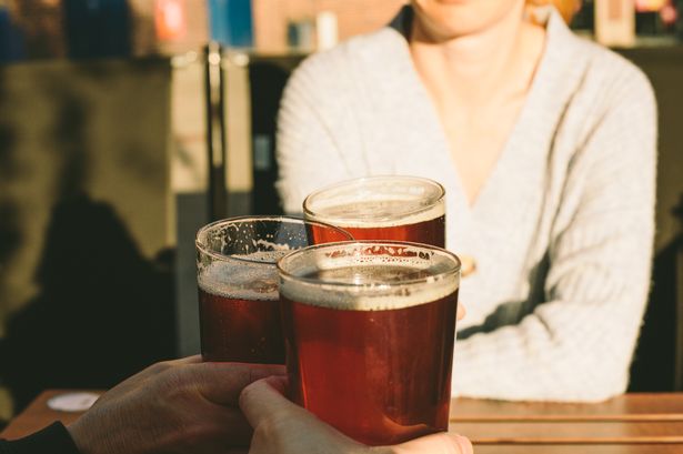 A picture of Women cheering with pints of beer