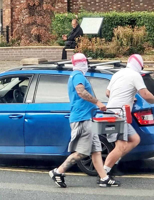 The two men were seen running through the streets of Walsall clutching pots of paint and paint rollers over the weekend