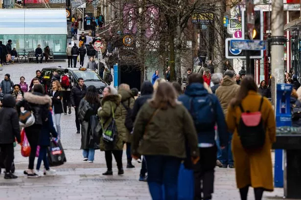 Shoppers walk along Buchanan Street in Glasgow