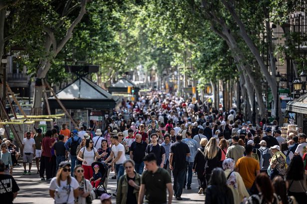 Pedestrians in Las Ramblas street in Barcelona, Spain, on Tuesday, May 27, 2025. Spain's government is pushing ahead with a controversial proposal to hit non-European Union residents with a 100% tax when buying homes, as it seeks to tackle a brewing housing crisis. Photographer: Angel Garcia/Bloomberg via Getty Images