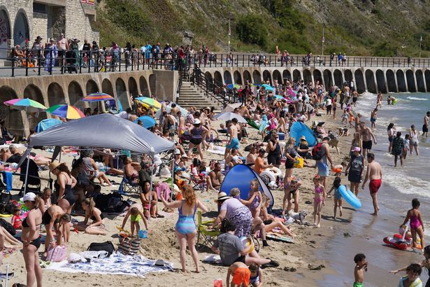 People enjoying the hot weather on Sunny Sands beach in Folkestone, as the third heatwave of the summer hits the UK with temperatures expected to remain high over the weekend.