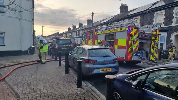 A fire engine in the middle of a residential street