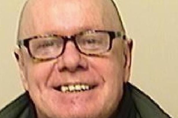 A man in glasses smiling at a camera