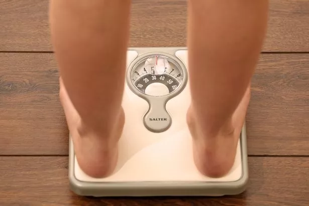Someone using a set of weighing scales