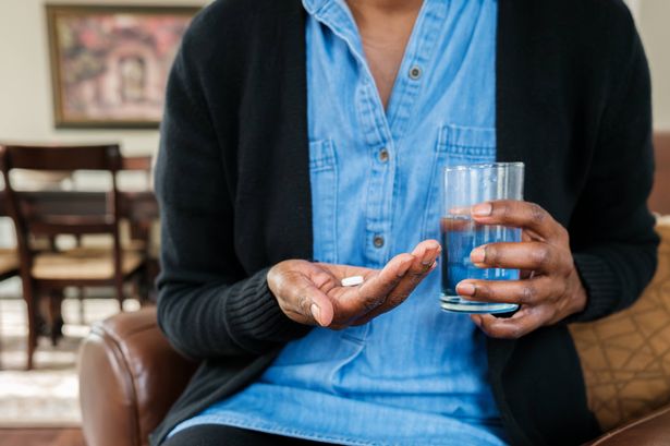 Woman taking medication, generic