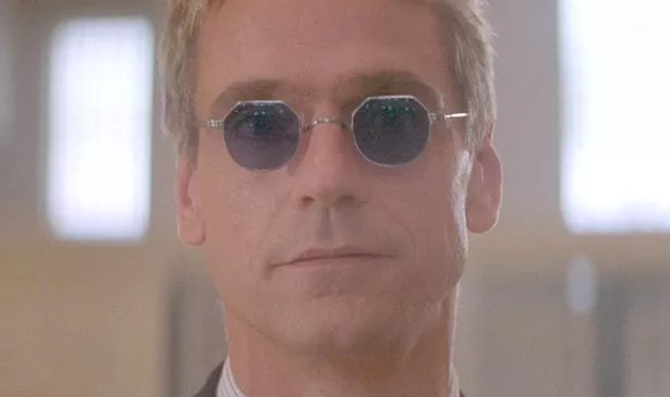 A man in sunglasses looks serious 