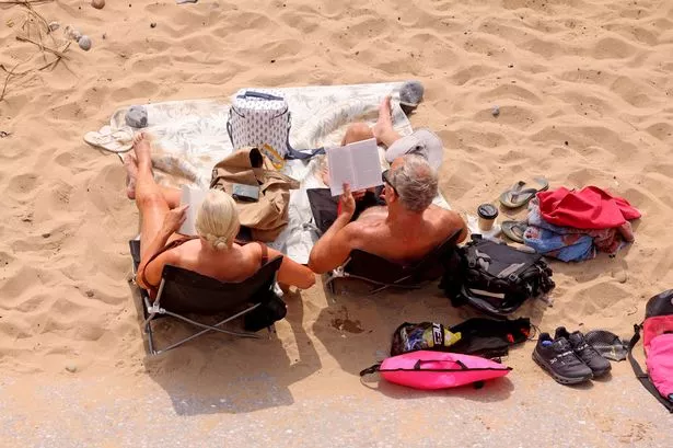 People Enjoying the sunshine at Langland Bay