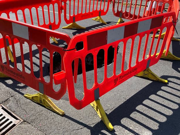 Workers placed barriers around the sinkhole in Ashton