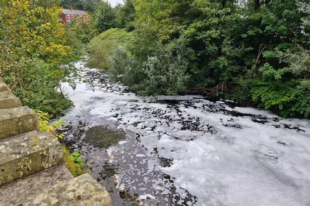 Foam flowing down the River Tame in Dukinfield
