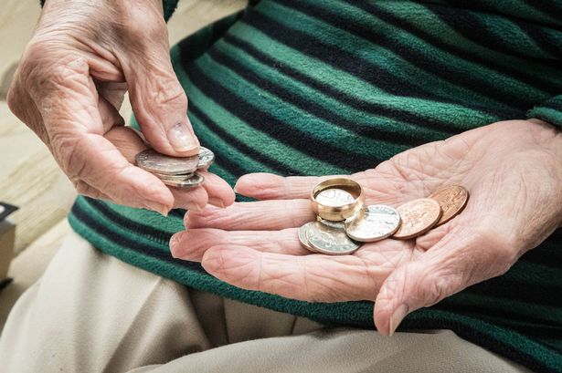 senior woman counting money - UK currency
