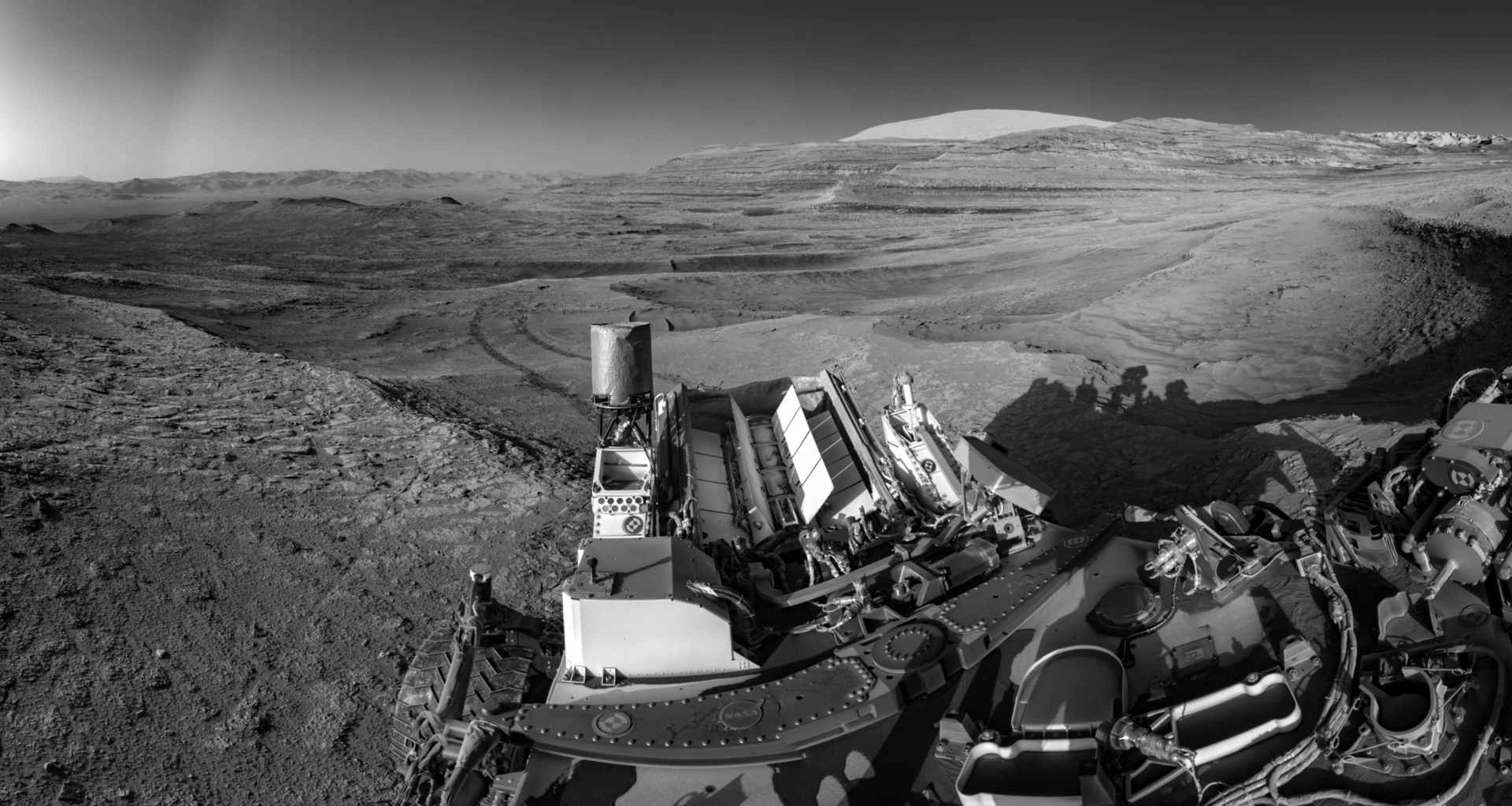 This view of tracks trailing behind NASA’s Curiosity was captured while the rover simultaneously relayed data to a Mars orbiter.