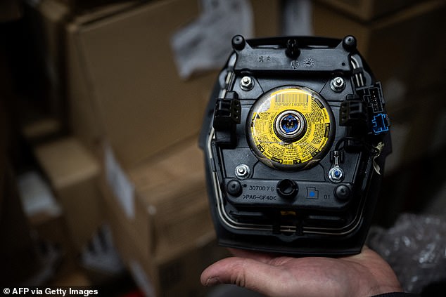 Stellantis has told the Daily Mail that around 66,000 C3 and DS3 models have so far had their faulty Takata airbags replaced. Pictured: a mechanic holds up a Takata airbag module