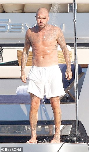 David showed off his toned frame as he went shirtless in the beachwear look while soaking up the sun