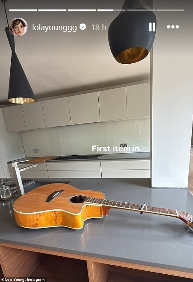 Lola also shared a snap of her empty kitchen with her guitar on the counter as she penned: 'First item in'