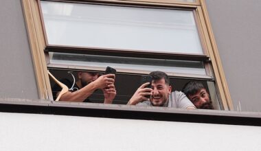 People believed to be migrants have been seen filming and laughing from a window at the Thistle City Barbican Hotel in London