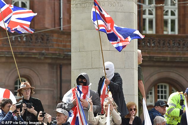 MANCHESTER: Masked supporters join the far-right Britain First party 'March for Remigration' rally