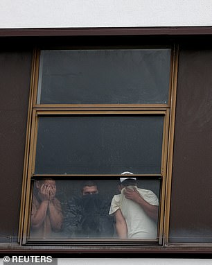Others attempted to cover their faces as they peered out of the window