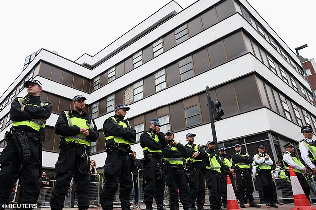 Police form a line between anti-immigration demonstrators and counter protesters outside the hotel