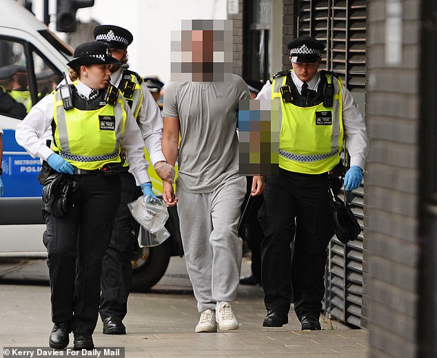 A protester being detained by police amid the Thistle Hotel Protest in Islington today