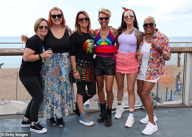 The loved-up duo were all smiles as they mingled with pals on Brighton's vibrant seafront