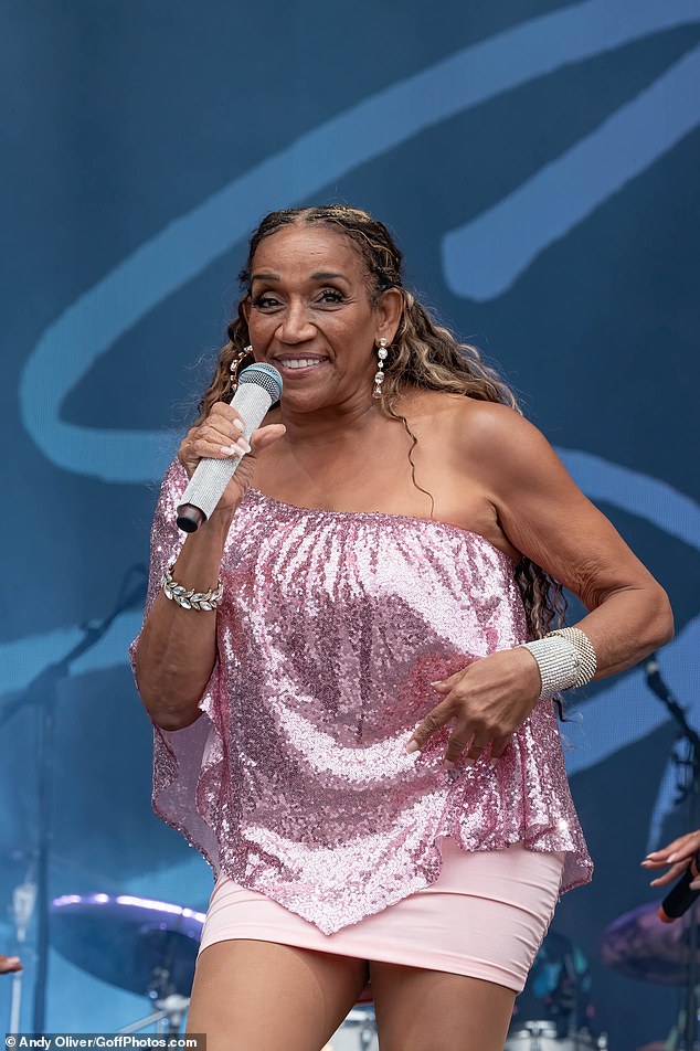 Lead singer Kathy Sledge, 66, dazzled in a pink asymmetric sequin-embellished top and a baby pink mini skirt, finishing the look with diamond drop earrings and a stack of sparkling bracelets