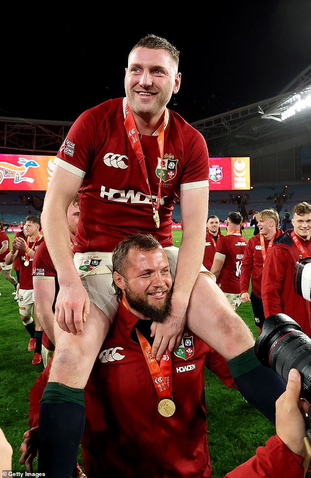 Finn Russell is pictured being chaired off the ground by teammate Pierre Schoeman after the Lions claimed a 2-1 series win despite the loss