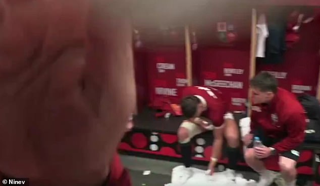 Pictured: A Lions staffer uses his hand to cover the camera in the dressing room after the damning footage was broadcast