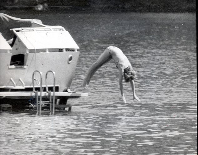Diana dives into the sea off the back of the King of Spain's yacht while on holiday in Majorca