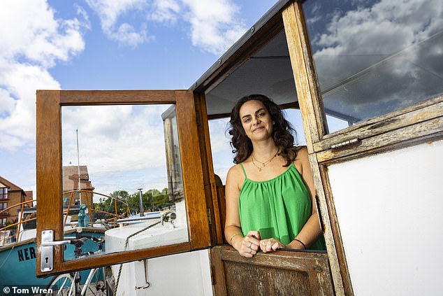 Lucy Barwick (pictured), 28, is saving £500 a month on bills - after ditching her flat and moving into a 48ft houseboat on Bristol Marina
