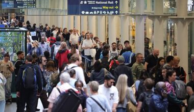 Passengers wait for trains in a busy London St Pancras international station today