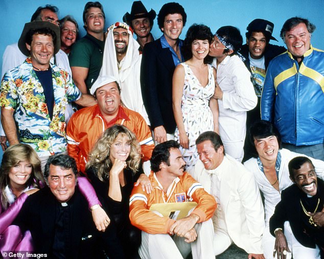 The cast of The Cannonball Run in 1981. Back row, left to right: Wise, Jack Elam (hidden), unknown, Joe Klecko, Jamie Farr, Mel Tillis, Bert Convy, Adrienne Barbeau, Michael Hui, Rick Aviles, and Warren Berlinger. Centre (in orange) Dom DeLuise. Front row, left to right: Tara Buckman, Dean Martin, Farrah Fawcett, Burt Reynolds, Roger Moore, Jackie Chan and Sammy Davis, Jr