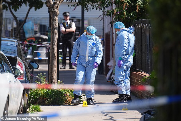 Forensic police officers at the scene at Dynevor Road, Stoke Newington yesterday