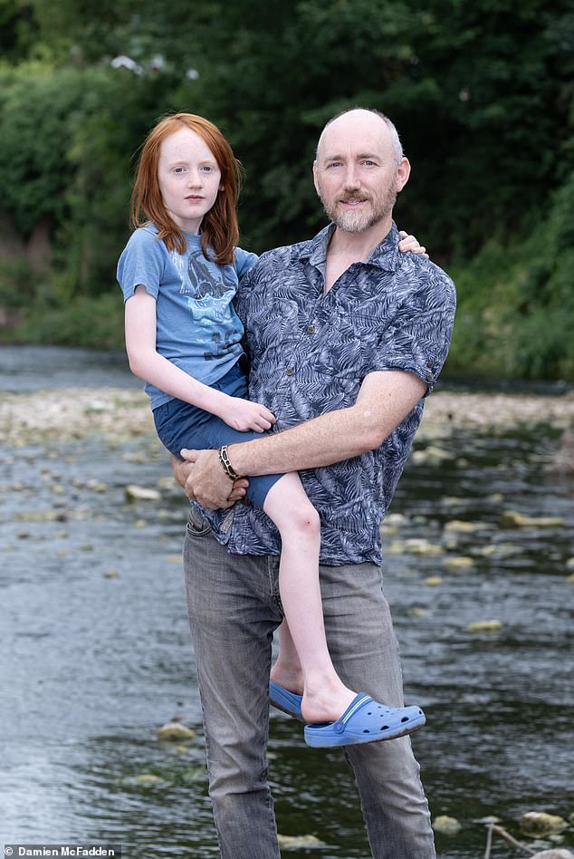 Kim Hilton with his son Lochryn. Kim says he is much more cautious about swimming in rivers after getting sick from wild swimming