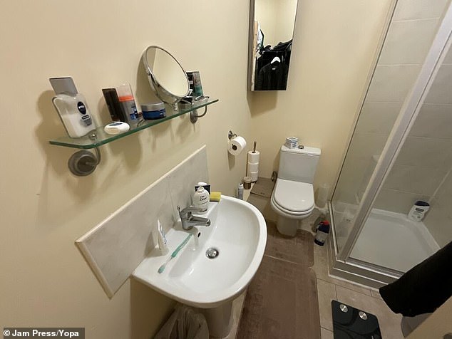 The narrow small room also includes a bathroom with, as expected, doesn't have much space either
